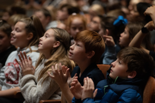 Young student applauding in an audience