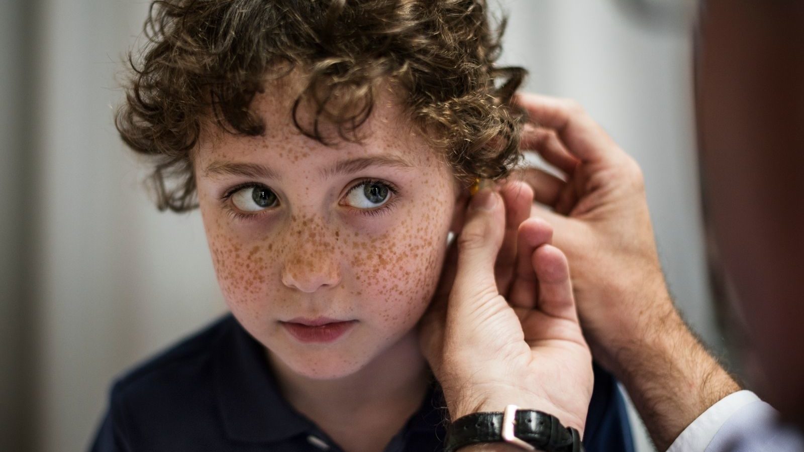 Kid getting help with a listening device