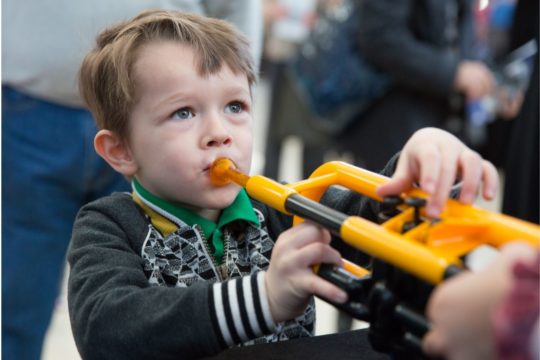 little boy visiting the instrument petting zoo at a MYDSO concert