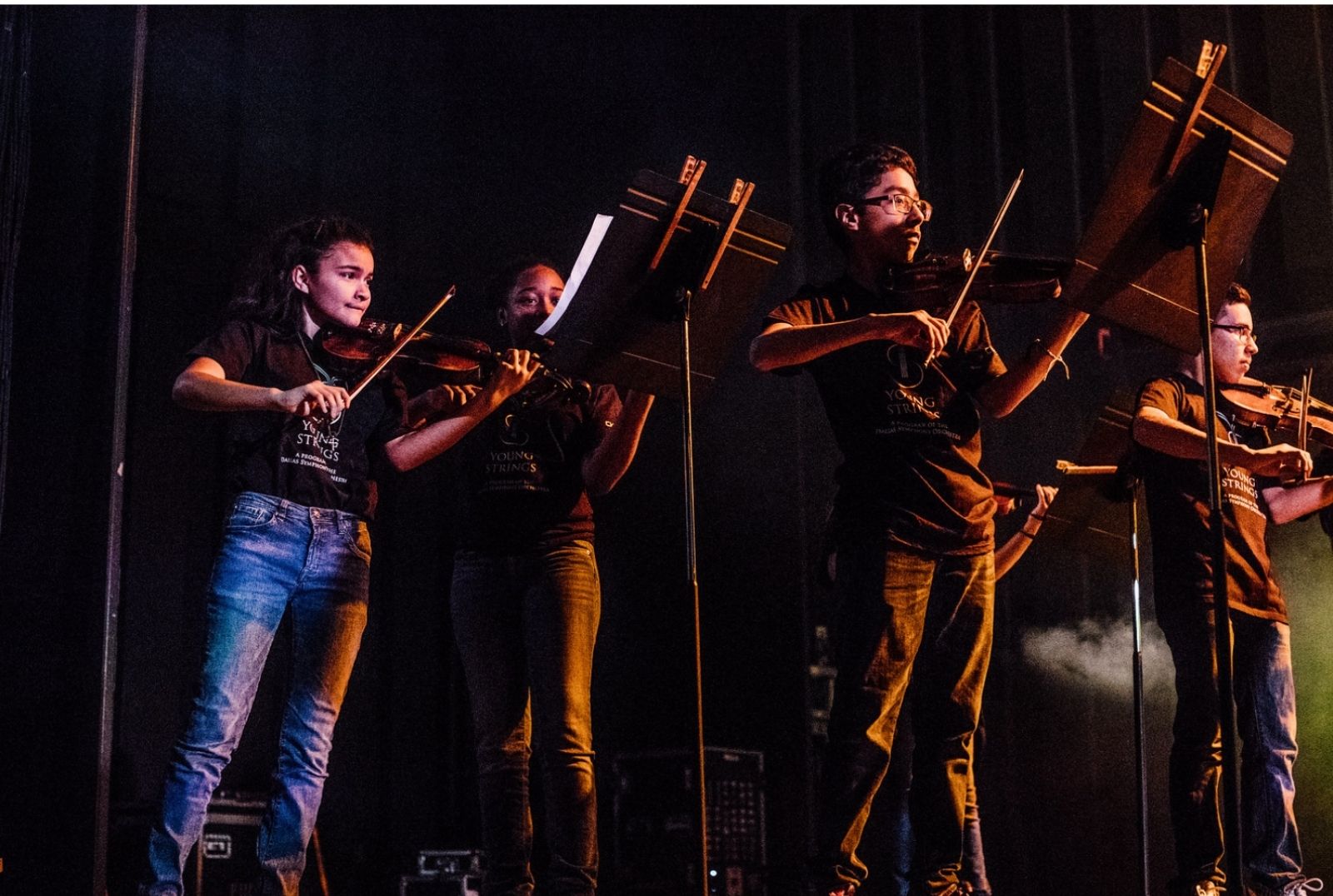 Young strings performing in concert