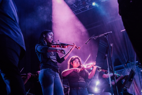 Young strings student play in concert