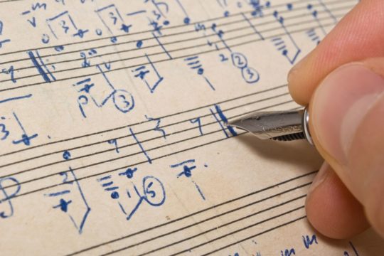 person composing a score