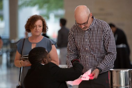 Usher helping guests with their tickets