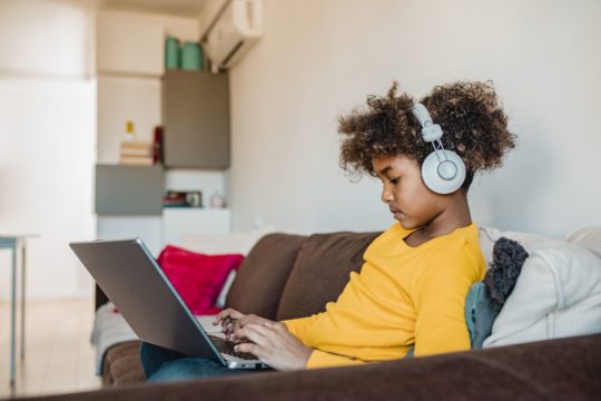 kid watching and listening on his computer