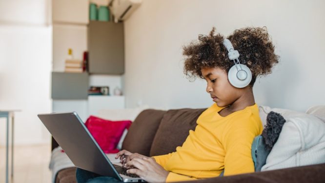 kid watching and listening on his computer