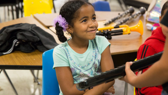 Girl smiles while touching keyboard