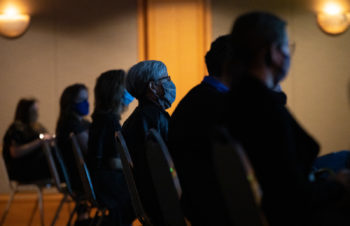 Five people sitting in darkened room