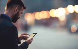 Man using his cell phone to donate his tickets