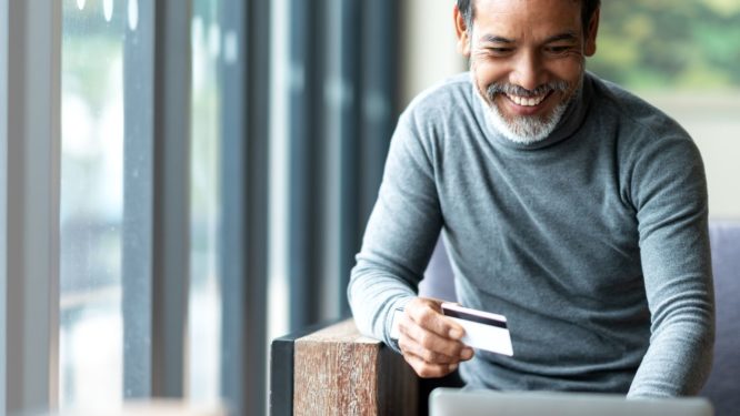 Hispanic man getting a great online deal
