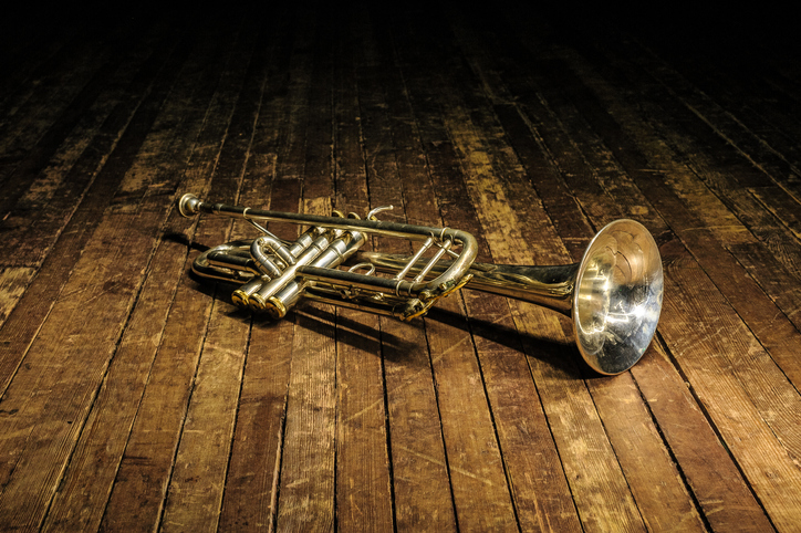 trumpet on a dark wooden floor