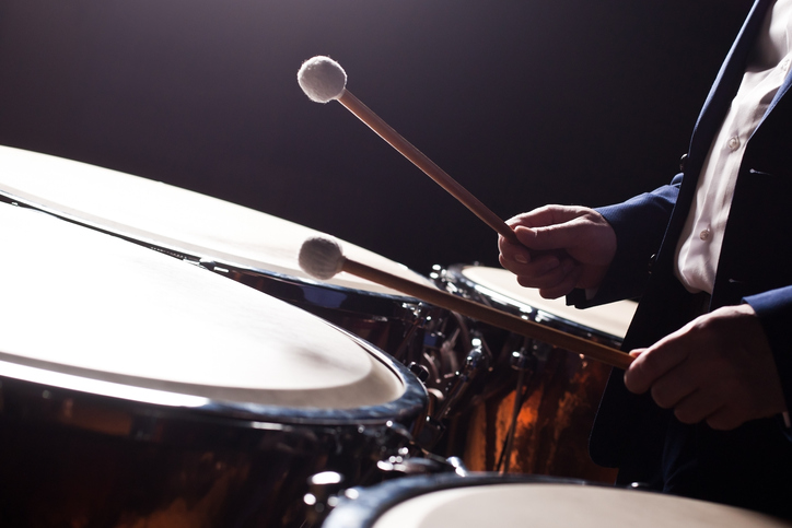 man playing timpani in an orchestra